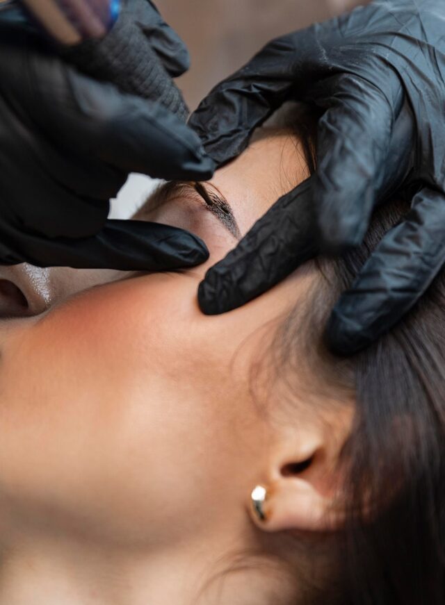 young-woman-getting-beauty-treatment-her-eyebrows