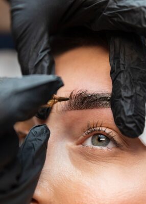 young-woman-getting-beauty-treatment-her-eyebrows